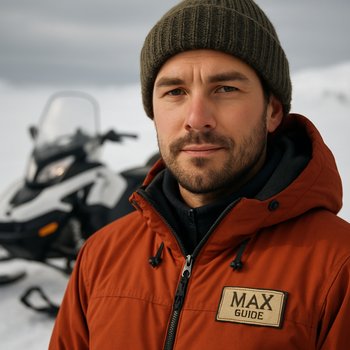 Гид Максим в шлеме снегохода на закате